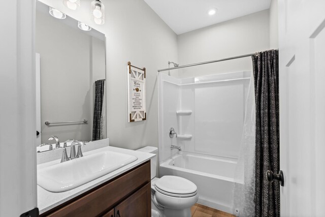 bathroom with shower / bath combo, a sink, and toilet