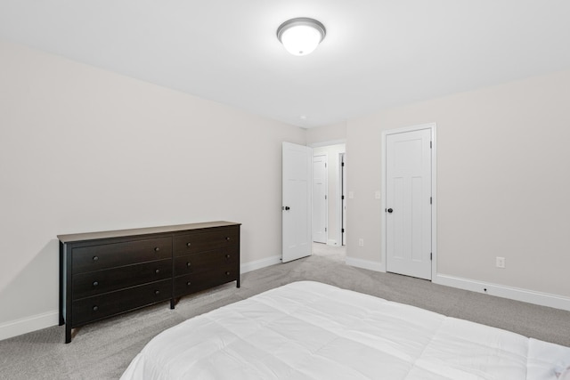 bedroom with baseboards and carpet