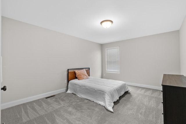 carpeted bedroom with visible vents and baseboards