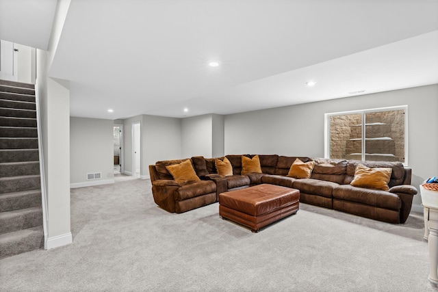 carpeted living area featuring recessed lighting, baseboards, visible vents, and stairway