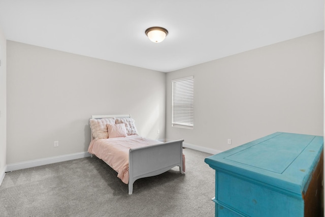 bedroom with carpet flooring and baseboards