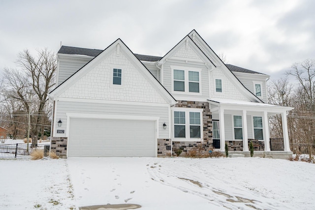 view of front of property with a garage, stone siding, and a porch