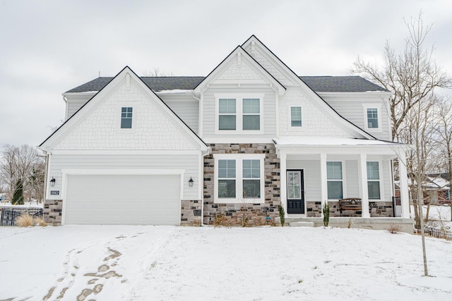 view of front facade featuring a porch, stone siding, and a garage