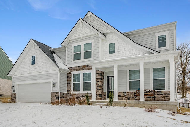 view of front of house featuring a garage and stone siding