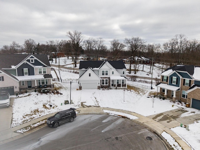 snowy aerial view with a residential view