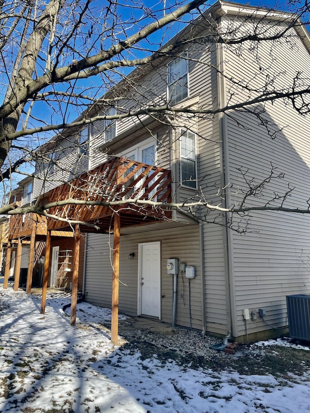 snow covered property featuring central air condition unit