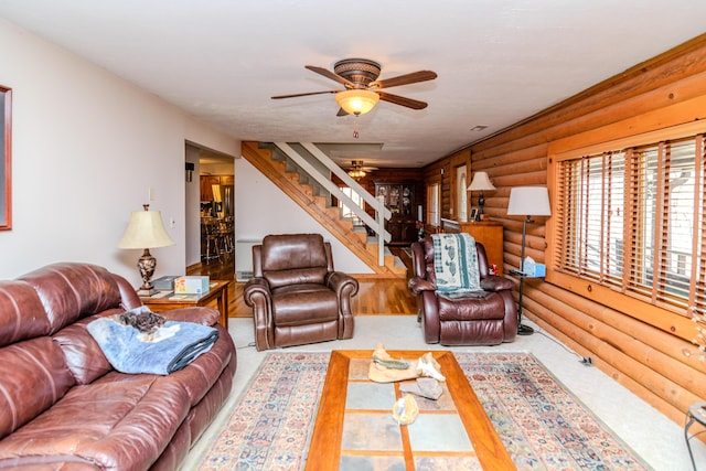 living room with ceiling fan and stairs