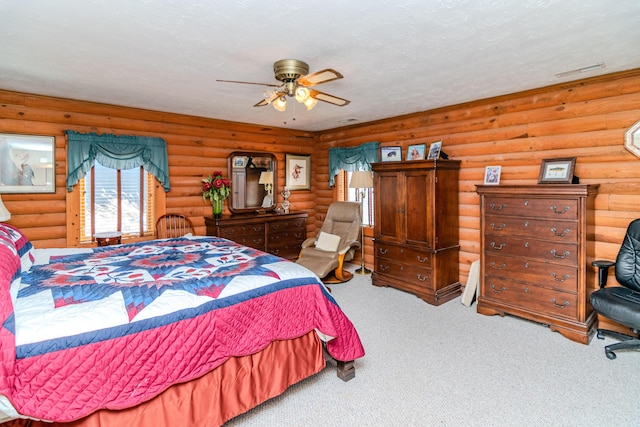 bedroom with rustic walls, carpet flooring, visible vents, and a textured ceiling