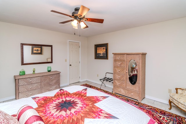 bedroom featuring a ceiling fan, baseboards, and light tile patterned floors