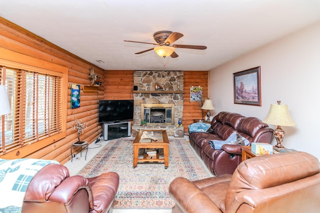 living room with ceiling fan, a stone fireplace, and rustic walls