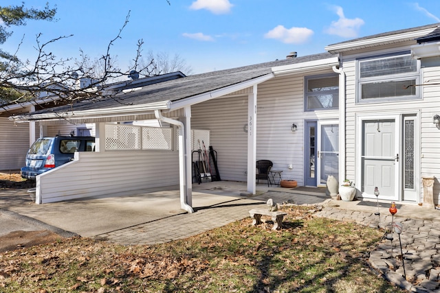 back of house featuring a carport