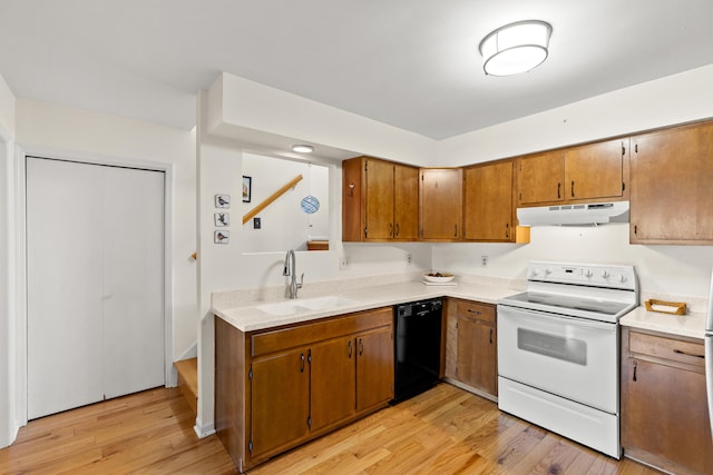 kitchen with light countertops, electric range, a sink, dishwasher, and under cabinet range hood