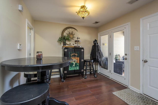 entryway with dark wood-style floors, baseboards, and visible vents