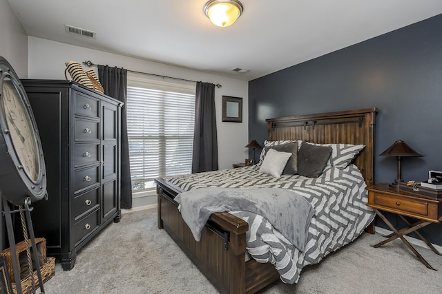 bedroom featuring light carpet and visible vents