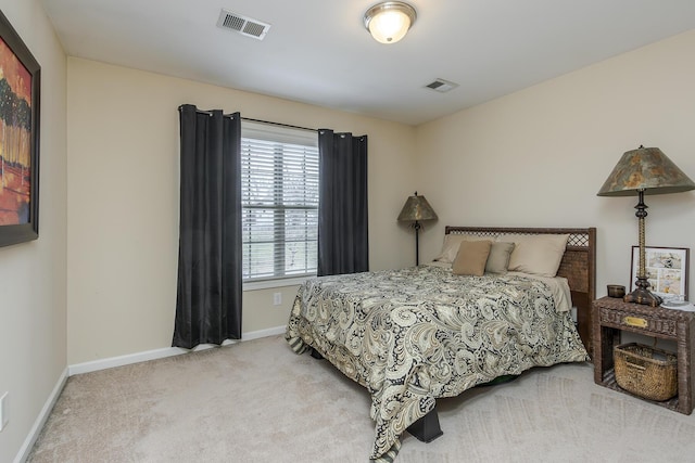 bedroom with light colored carpet, visible vents, and baseboards