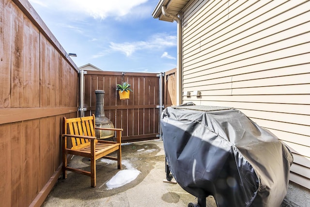 view of patio with area for grilling and fence