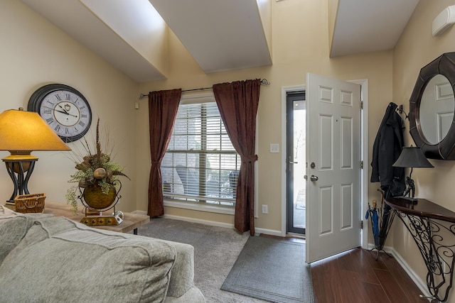 foyer entrance with dark wood finished floors and baseboards