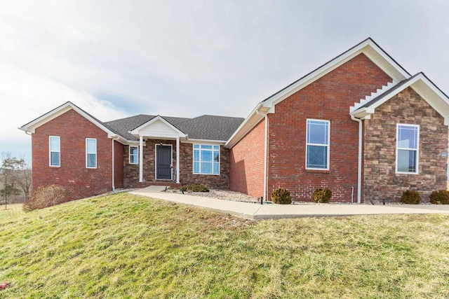 ranch-style house with stone siding, brick siding, and a front lawn