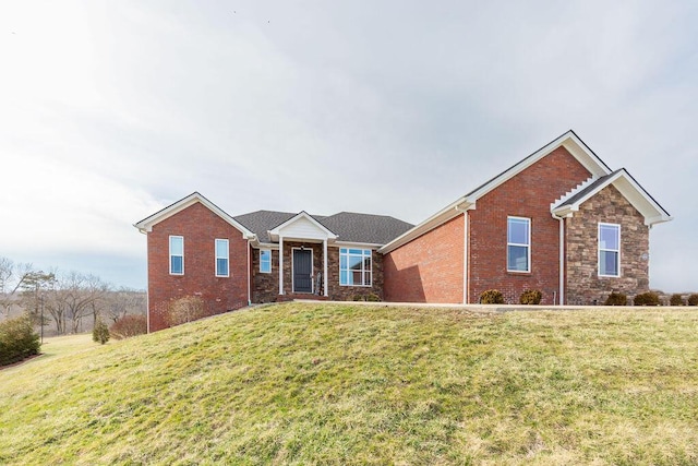 ranch-style house featuring brick siding and a front lawn