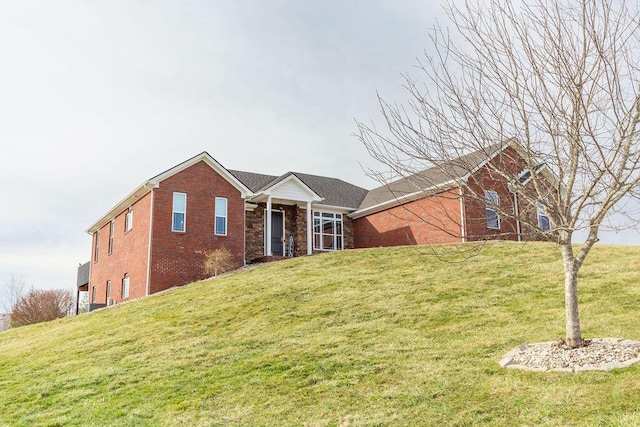 ranch-style home with a front yard and brick siding