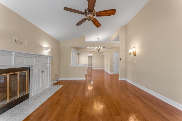 1649 Silver Pheasant Cir, Lexington, KY 40511 - unfurnished living room featuring baseboards, vaulted ceiling, a fireplace, ceiling fan with notable chandelier, and wood finished floors