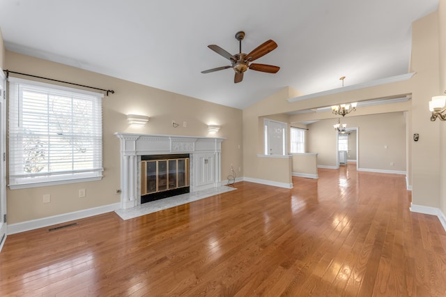 1649 Silver Pheasant Cir, Lexington, KY 40511 - unfurnished living room featuring visible vents, a high end fireplace, light wood finished floors, vaulted ceiling, and ceiling fan with notable chandelier