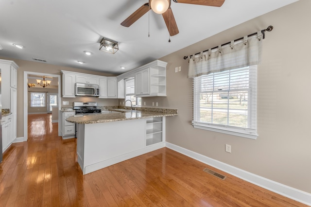 1649 Silver Pheasant Cir, Lexington, KY 40511 - kitchen with a peninsula, open shelves, visible vents, stainless steel appliances, and a sink