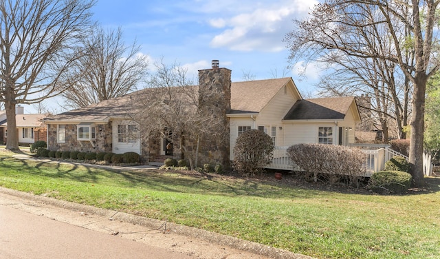 single story home featuring stone siding, a chimney, and a front lawn