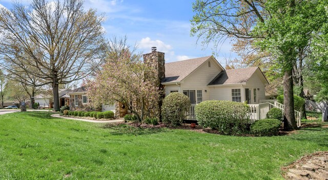 1649 Silver Pheasant Cir, Lexington, KY 40511 - view of side of property with a lawn, roof with shingles, a chimney, a garage, and a deck