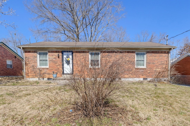 view of front of home featuring brick siding, crawl space, and a front yard