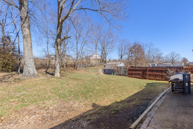 view of yard with an outdoor structure and fence