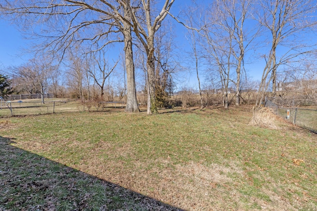 view of yard featuring fence and a rural view