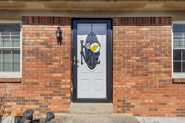 view of exterior entry with brick siding