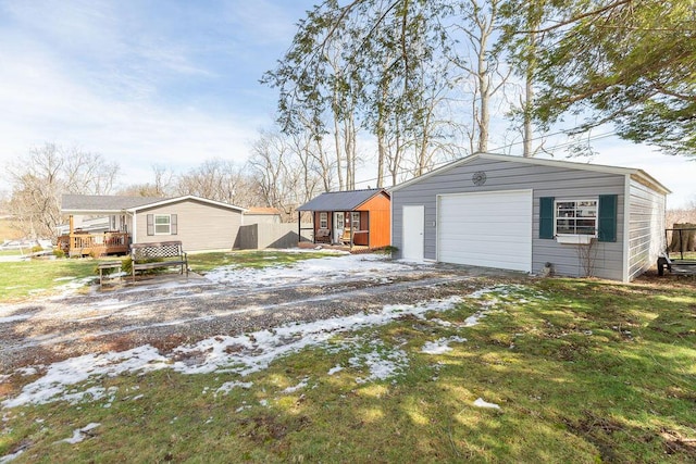 exterior space with a garage and an outbuilding