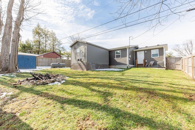 view of yard with entry steps and a fenced backyard