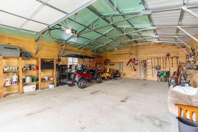 garage with a garage door opener and metal wall