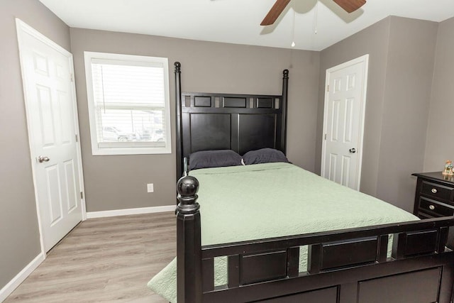 bedroom with a ceiling fan, light wood-type flooring, and baseboards