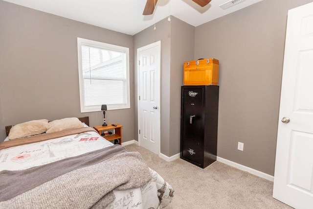 bedroom featuring a ceiling fan, light carpet, visible vents, and baseboards