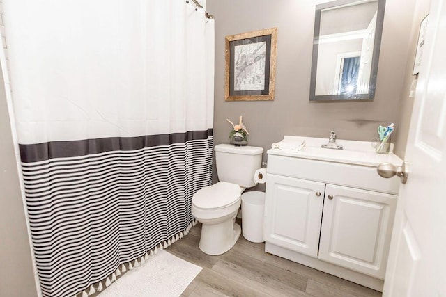 full bathroom with vanity, toilet, and wood finished floors