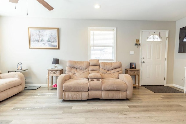 living area with a ceiling fan, recessed lighting, baseboards, and light wood finished floors