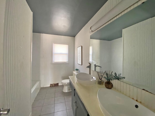 full bath featuring toilet, tile patterned flooring, and double vanity