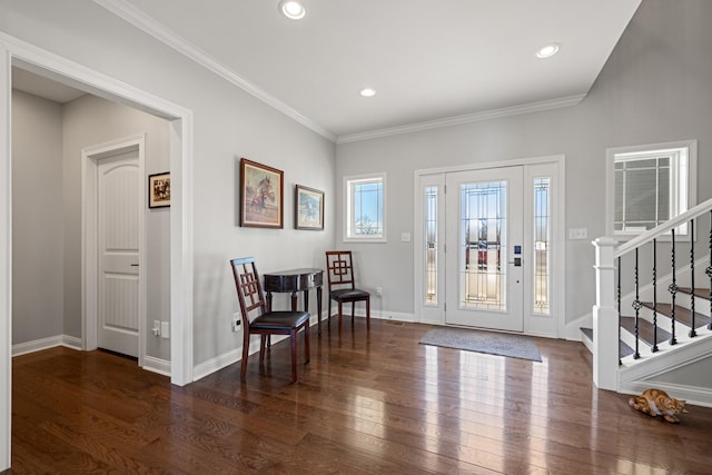 entrance foyer with ornamental molding, baseboards, stairway, and hardwood / wood-style floors