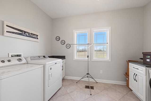 clothes washing area with cabinet space, light tile patterned floors, visible vents, and independent washer and dryer