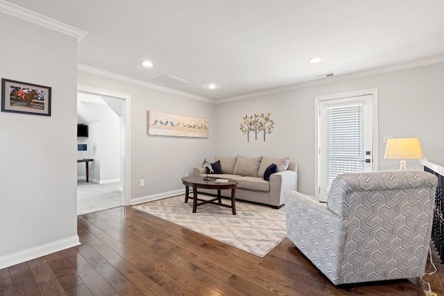 living area featuring visible vents, crown molding, baseboards, and hardwood / wood-style flooring