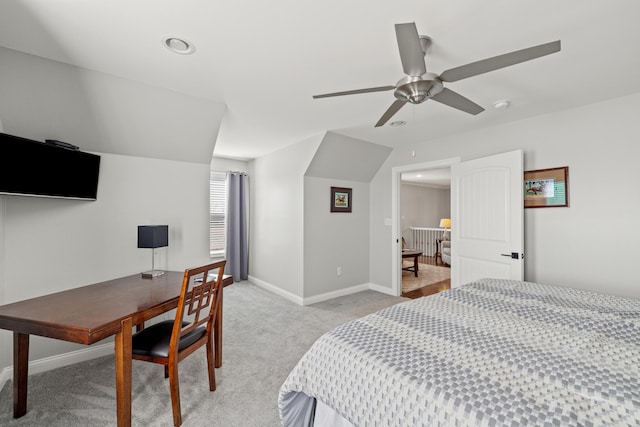 bedroom featuring light carpet, vaulted ceiling, and baseboards