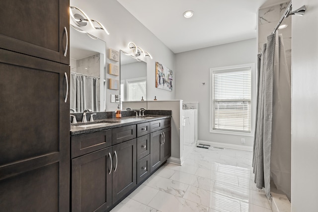 full bath with marble finish floor, a wealth of natural light, and a sink