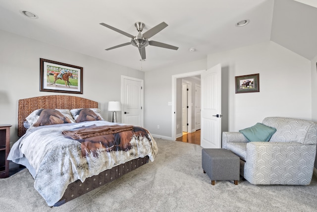 carpeted bedroom with ceiling fan, lofted ceiling, and baseboards