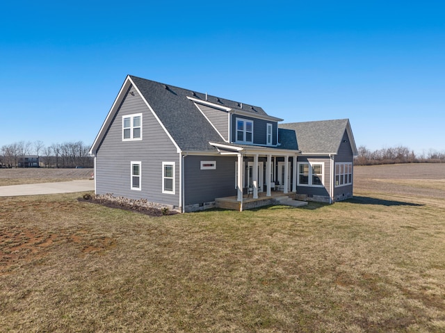 back of property featuring crawl space, a shingled roof, a porch, and a yard