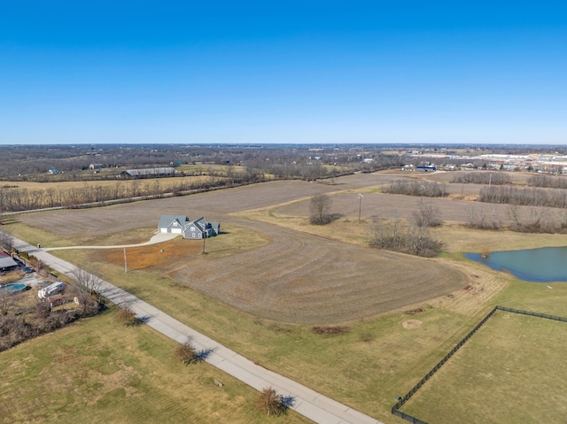 birds eye view of property featuring a water view and a rural view