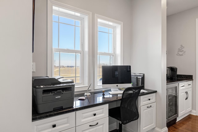 office area featuring dark wood-style floors, beverage cooler, and baseboards